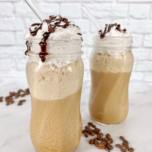 frappuccino in clear glasses with cream on top.