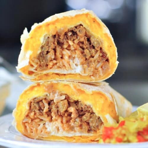 A cheesy quesarito sliced in half and stacked to show insides - rice, beans, and tomato salsa wrapped in a cheese layer of quesadilla.