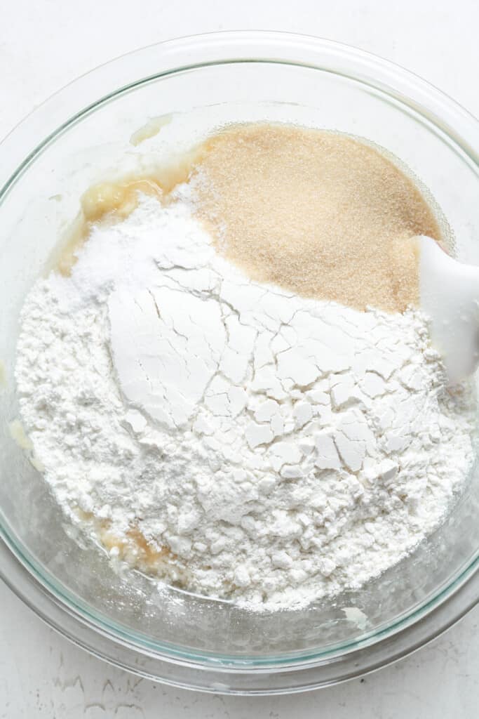 Flour, sugar and bananas in a bowl.