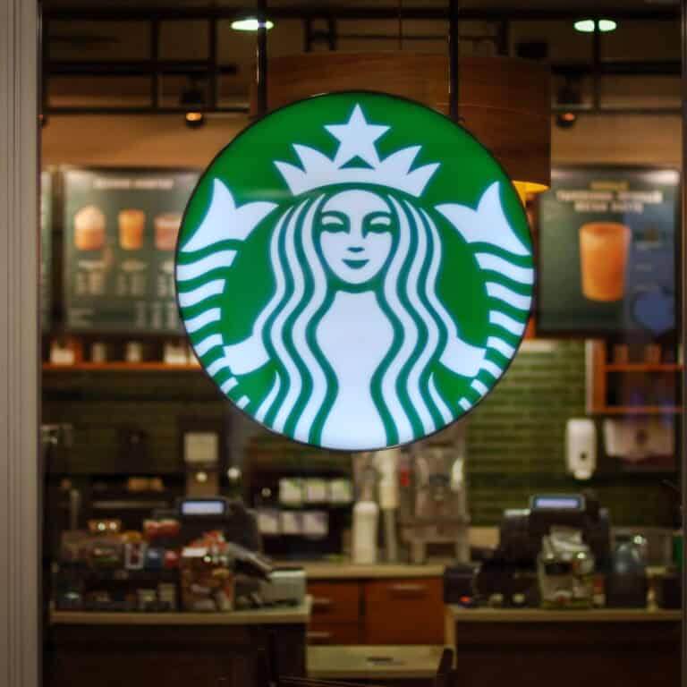 starbucks logo hanging outside coffee shop