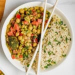 Vegan Curry served with Rice in a white bowl with chopsticks on top