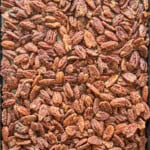 Sweet Crunchy Cinnamon and Sugar Roasted Pecans in a baking sheet out of the oven