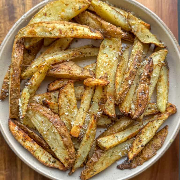 truffle fries seasoned with parmesan cheese on a plate - main pic