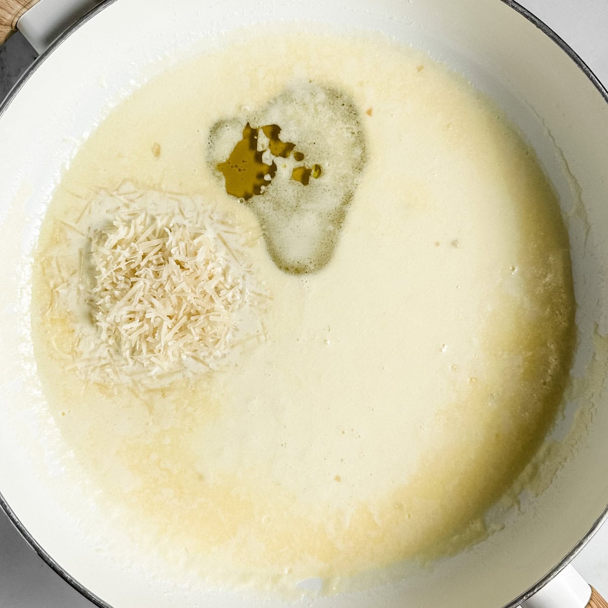 Step 3 - adding the truffle oil and grated parmesan cheese
