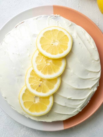 vegan-Lemon-Cake-with-sliced-lemons-on-top served on a plate