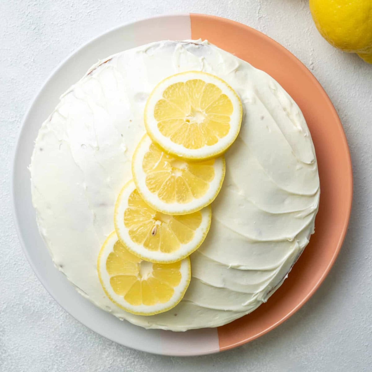 vegan-Lemon-Cake-with-sliced-lemons-on-top served on a plate