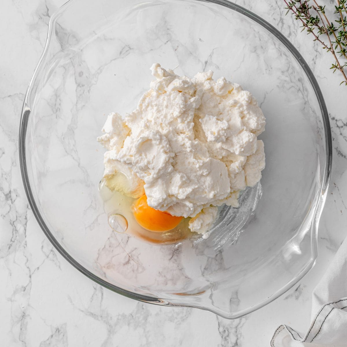 process 1 - cracked egg and ricotta cheese in a bowl