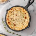 Baked Ricotta Dip in an Iron cast pan with fresh herbs on the side