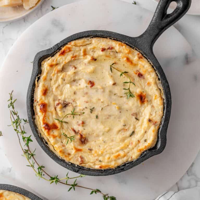 Baked Ricotta Dip in an Iron cast pan with fresh herbs on the side