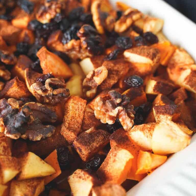 Baked apple and sweet potato casserole in a white baking dish