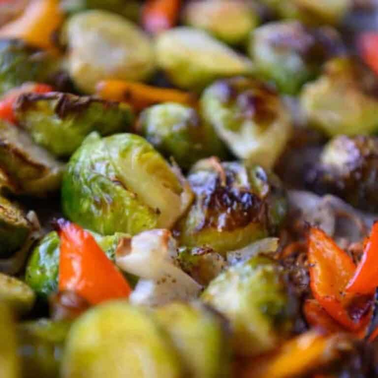 Close-up view of roasted brussels sprouts with red peppers and shallots