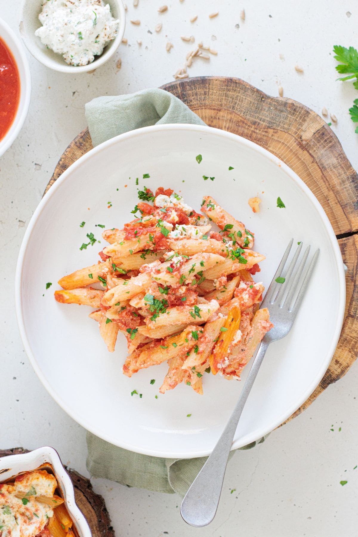 overhead of vegan baked ziti on a white plate with fork on the side of the plate