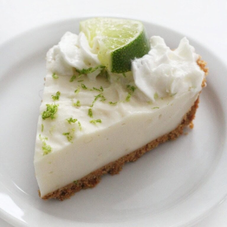 a slice of no-bake vegan key lime pie garnished with grated fresh lime