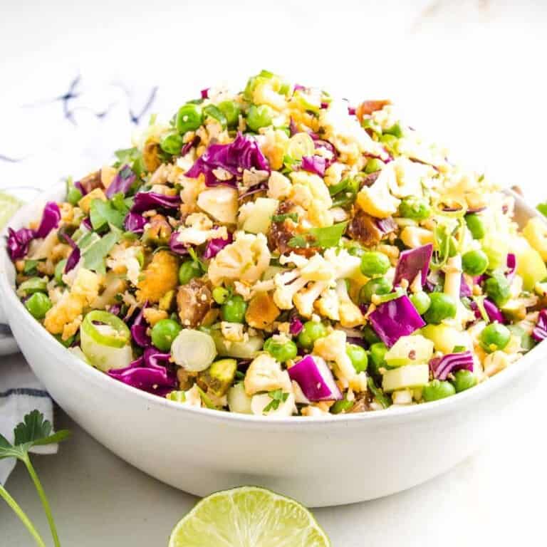 a colorful raw cauliflower salad with lime on a bowl