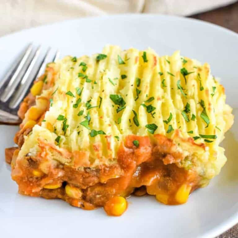 Vegan Shepherd's Pie garnished with herbs in a white plate