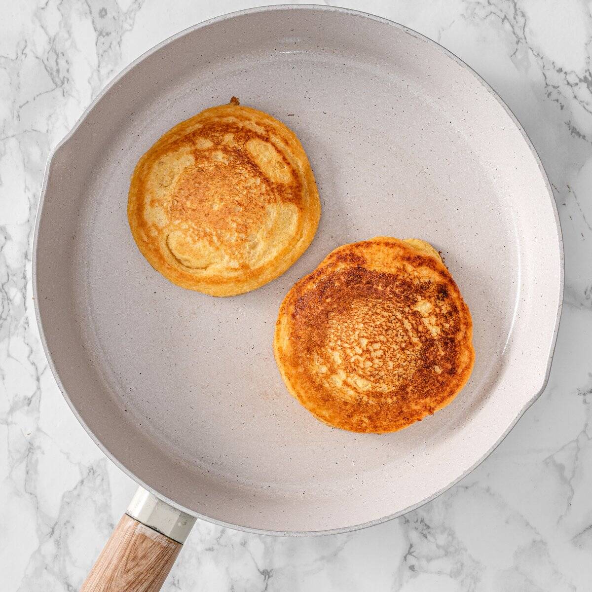 Golden brown chickpea flour pancake flipped on a pan