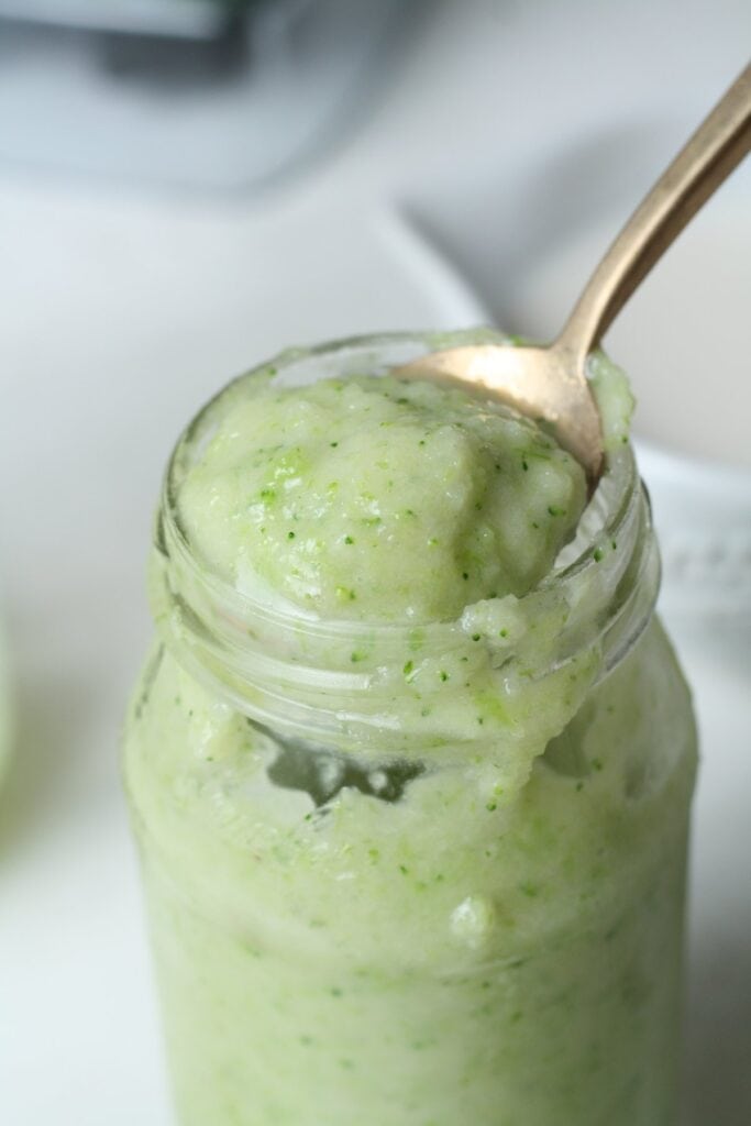 spoon full of Green protein smoothie photo with kale, spinach