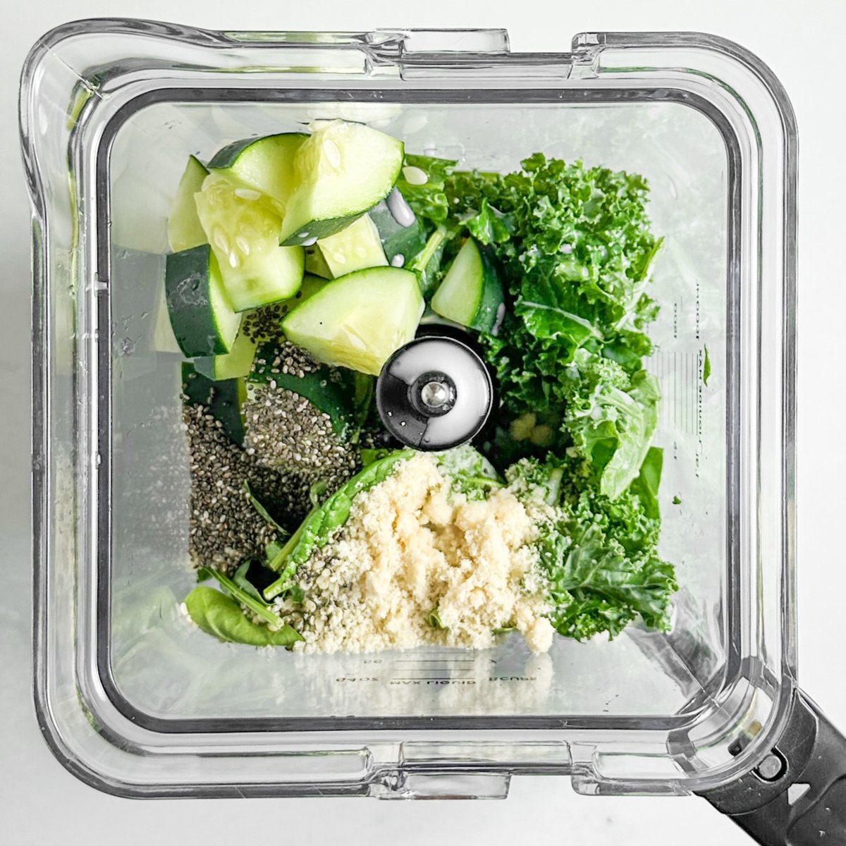 All smoothie ingredients added to blender including seeds and protein powder