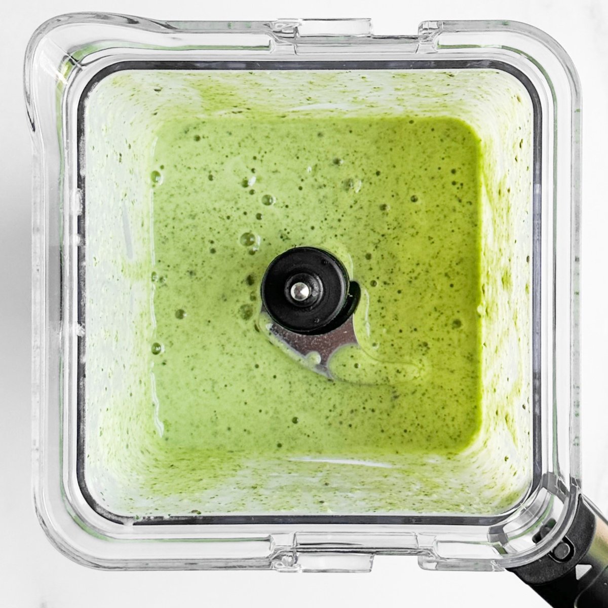 Blended green protein smoothie with creamy smooth texture