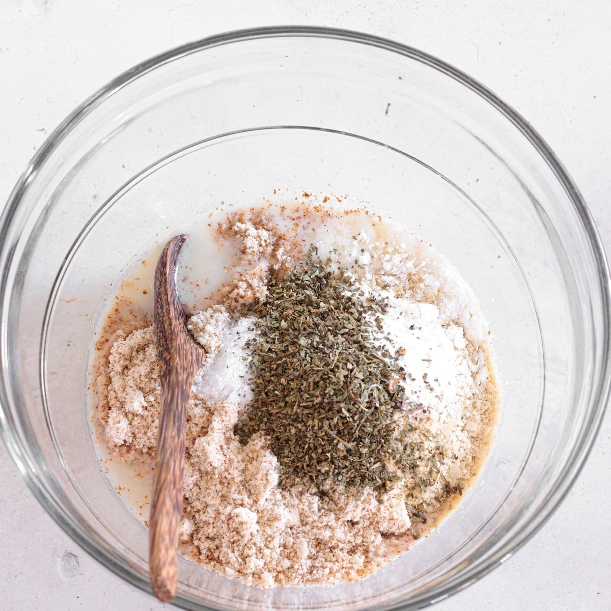 Biscuit dough mixed together in a bowl with almond milk