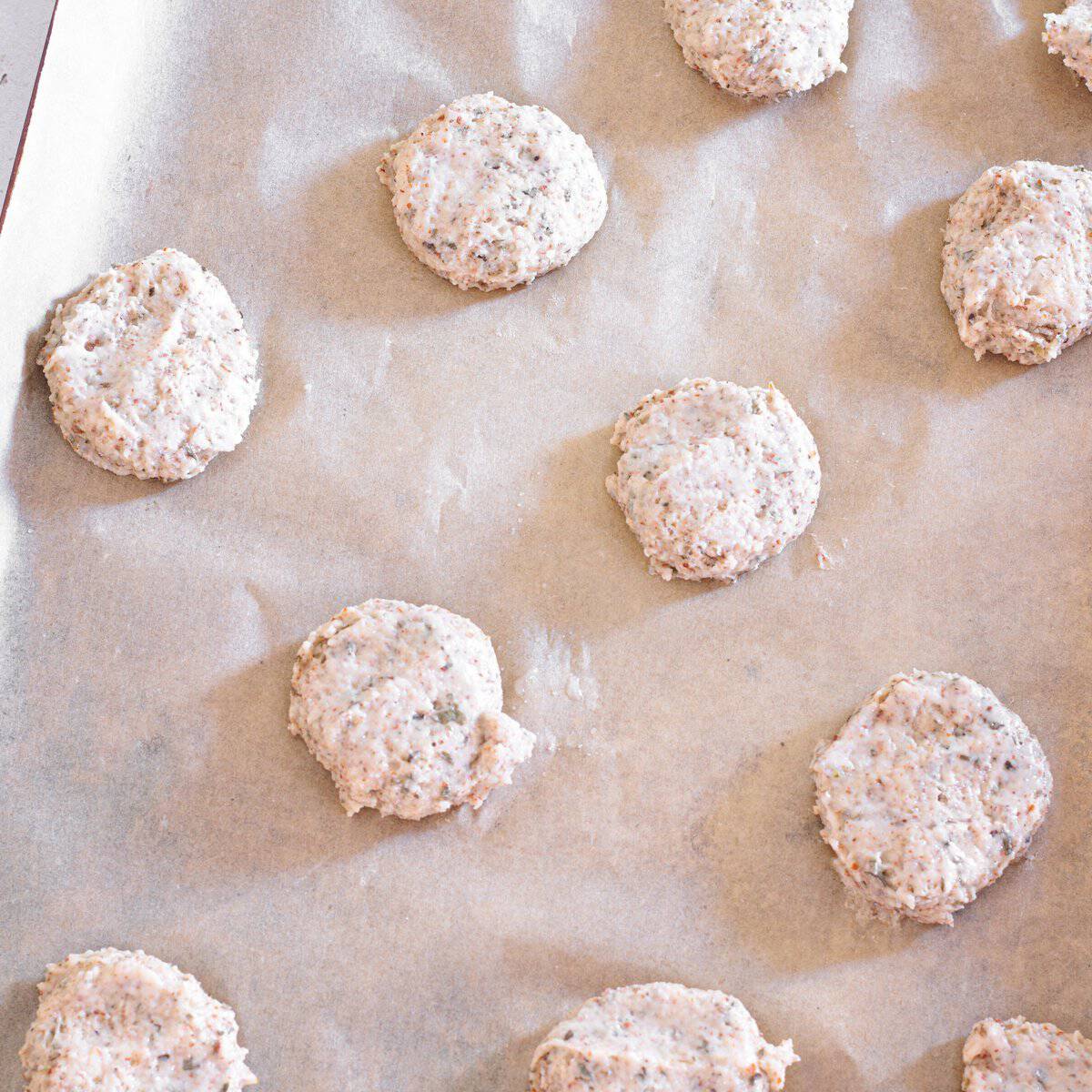 Biscuits pressed down on baking sheet ready for oven