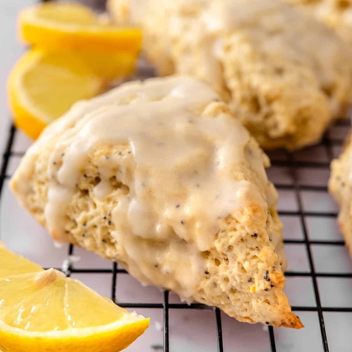 Vegan Lemon Poppy Seed Scones with Lavender Icing on a Wire Cooling Rack