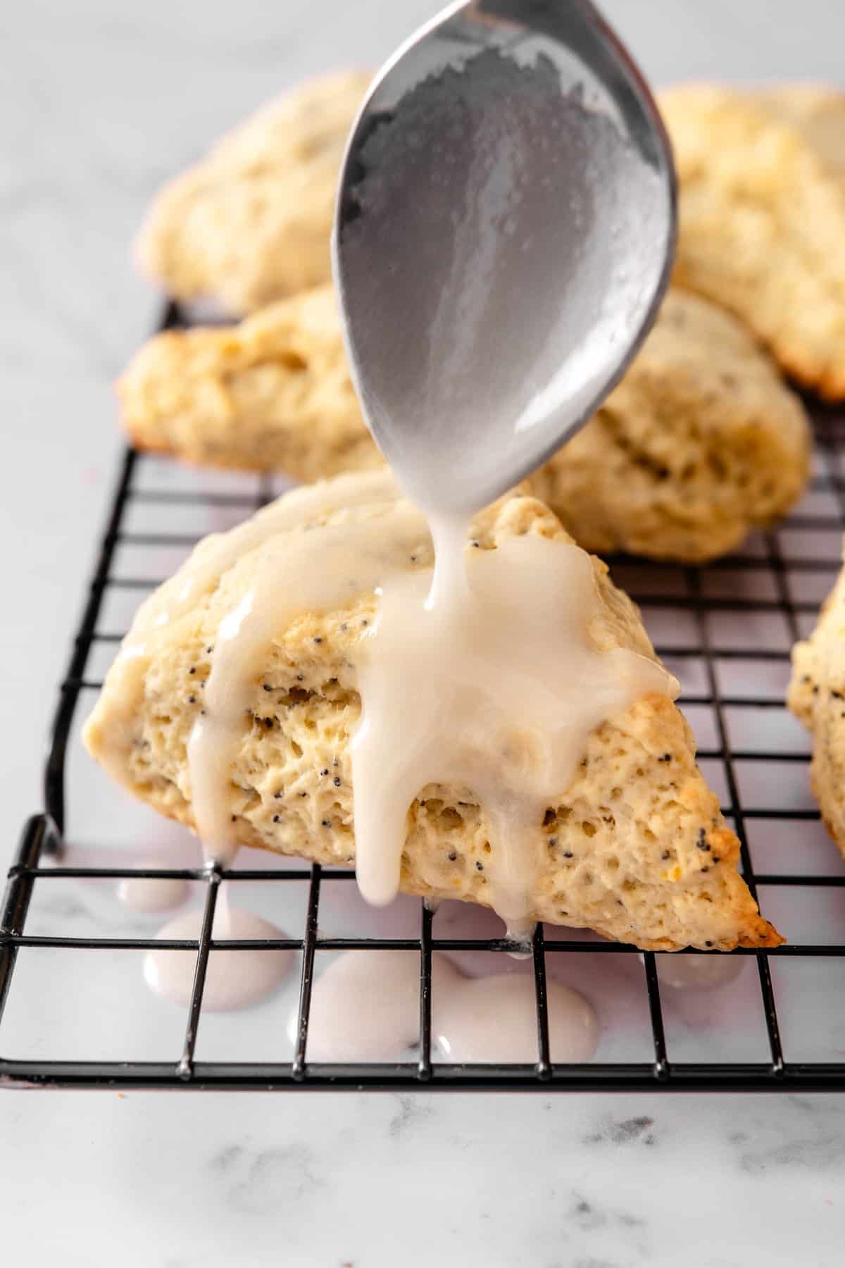 Close-up of vegan lemon poppy seed scones with soft crumbs and poppy seeds visible throughout