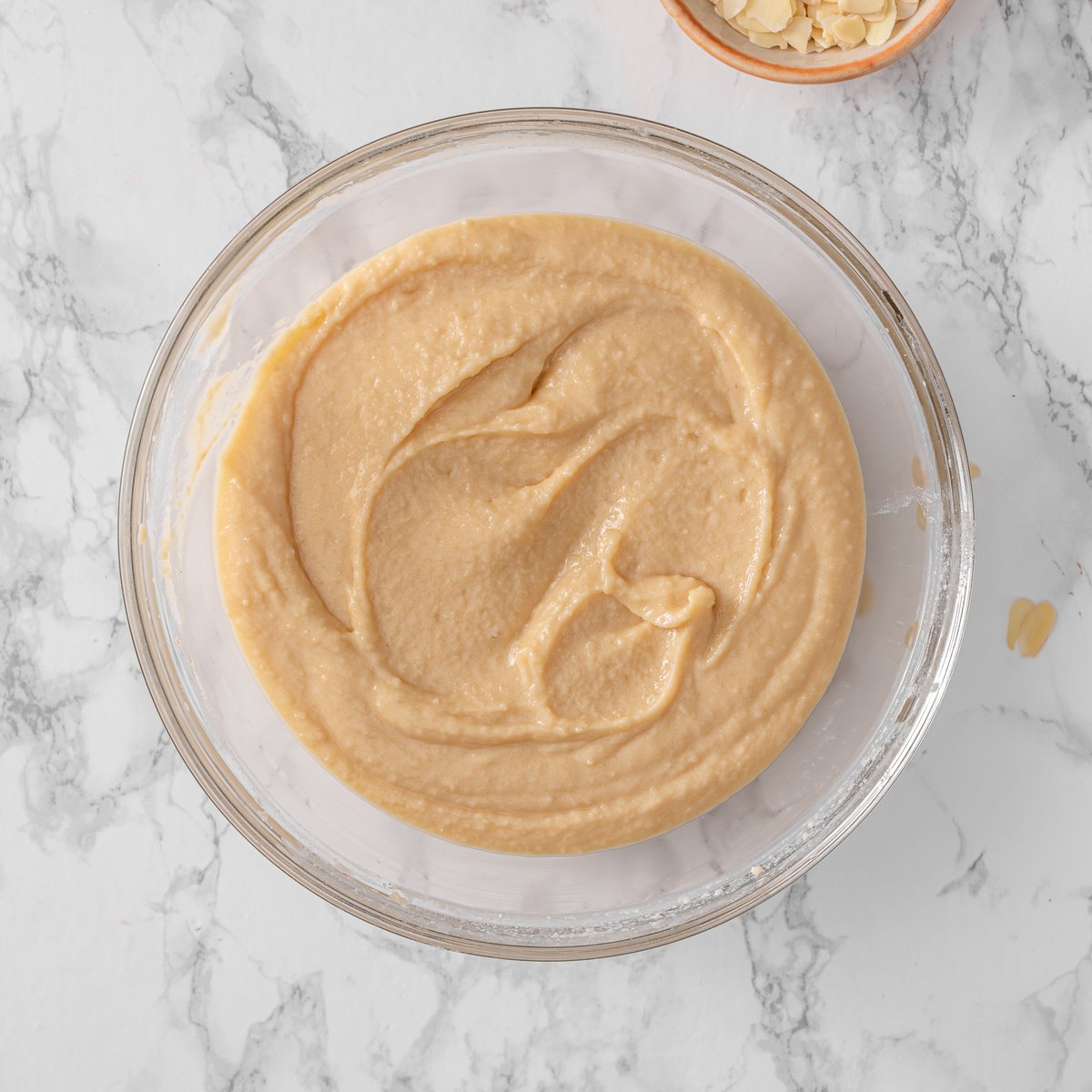 Cake batter in a bowl mixed with dry and wet ingredients.