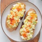 Avocado Cottage Cheese Toast on a white plate drizzled with hot sauce