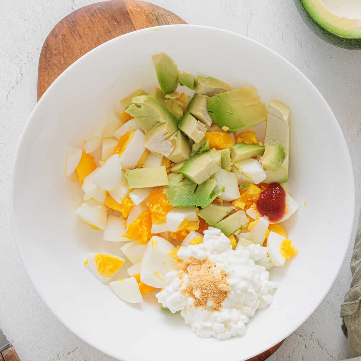 Avocado Cottage Cheese Toast step 3 - cottage cheese added in