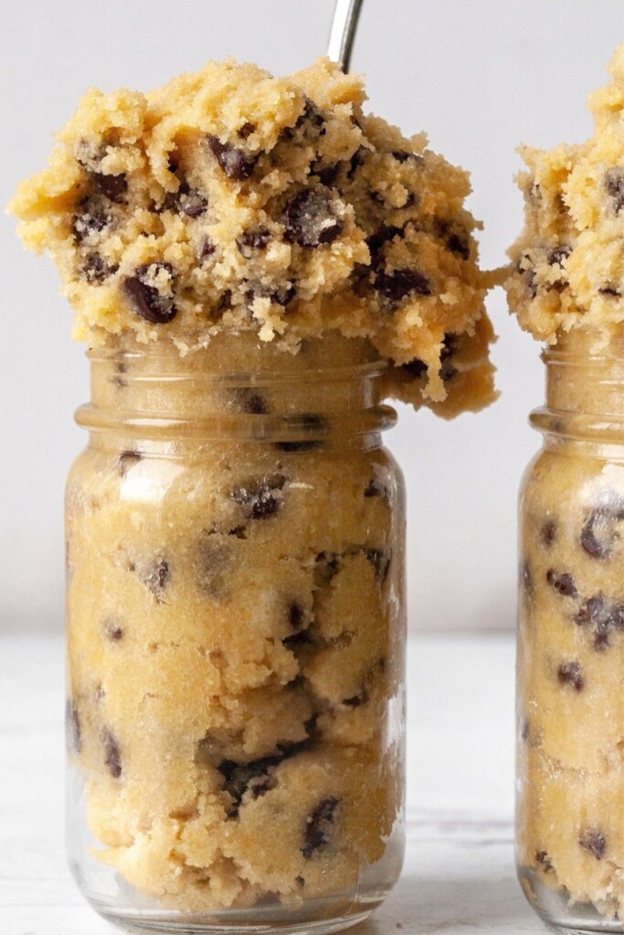 chickpea cookie dough in a mason jar with a spoon on the top